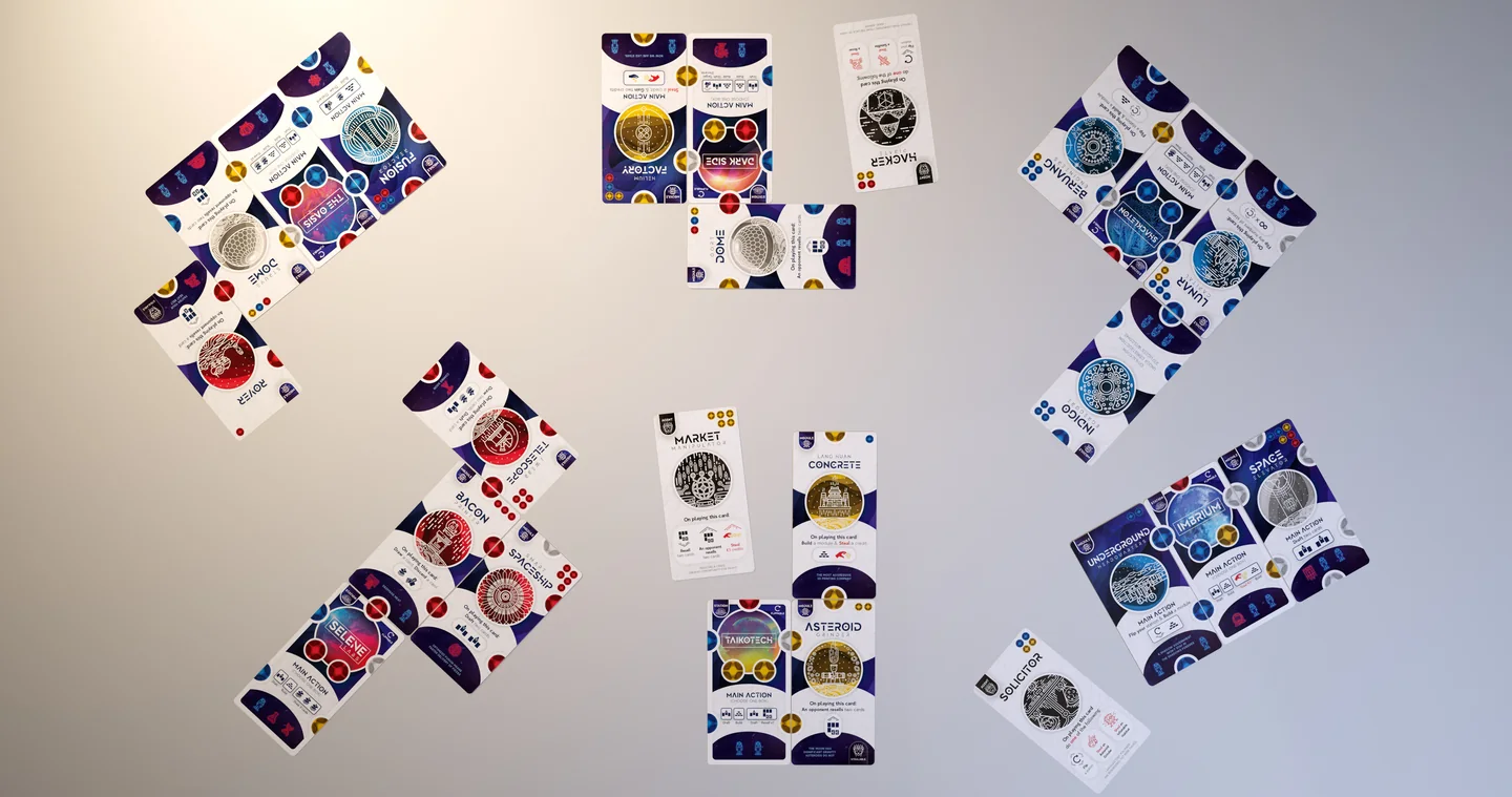 A complete Lunar Base game in progress seen from above, with six branching player bases and cards arranged around the shared play area.